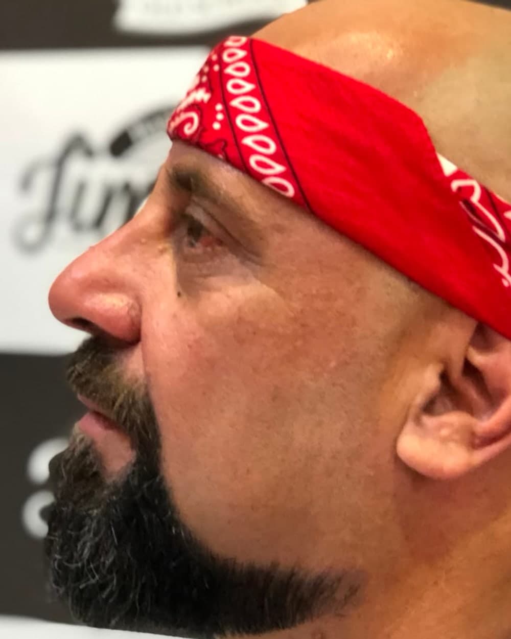 Cliente da Jimmy K com barba cheia bem cuidada, de perfil